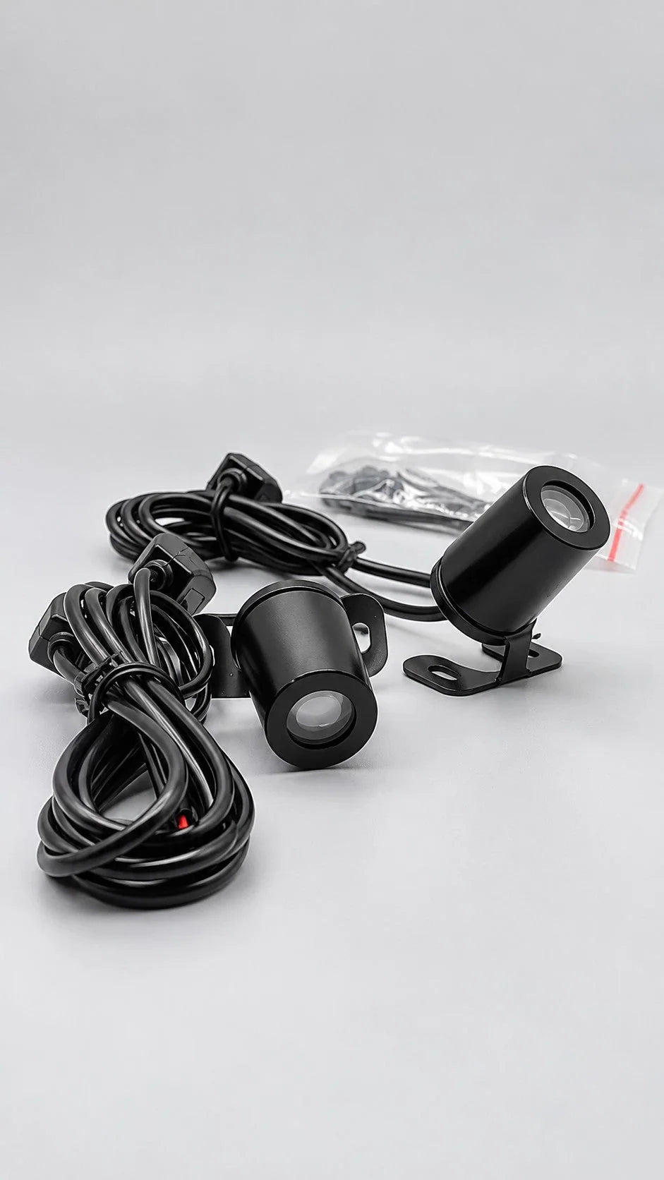 Two compact projectors with wiring and mounting brackets